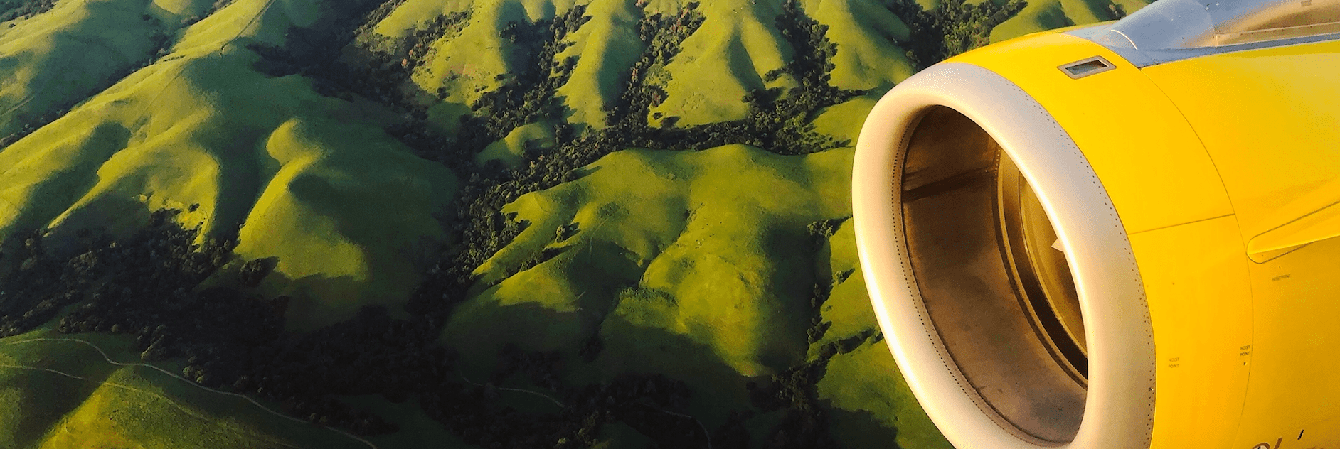 Green valley with yellow plane engine